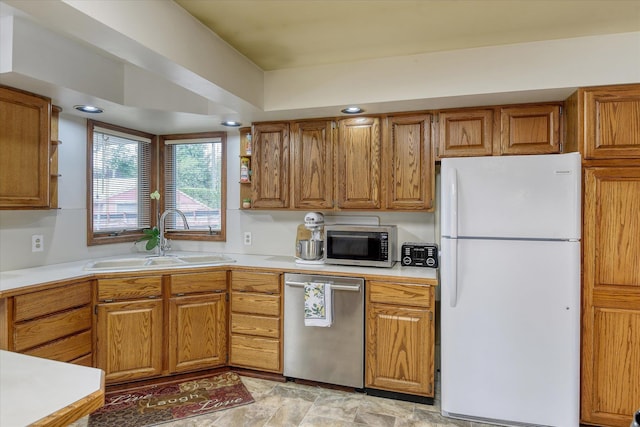 9509 N Atlantic St, Spokane, WA 99218 - kitchen with stainless steel appliances, a sink, light countertops, brown cabinets, and stone finish flooring