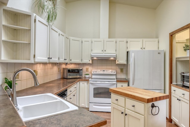 6923 N Hamilton St Unit 6923, Spokane, WA 99208 - kitchen featuring white appliances, under cabinet range hood, butcher block counters, a sink, and tasteful backsplash