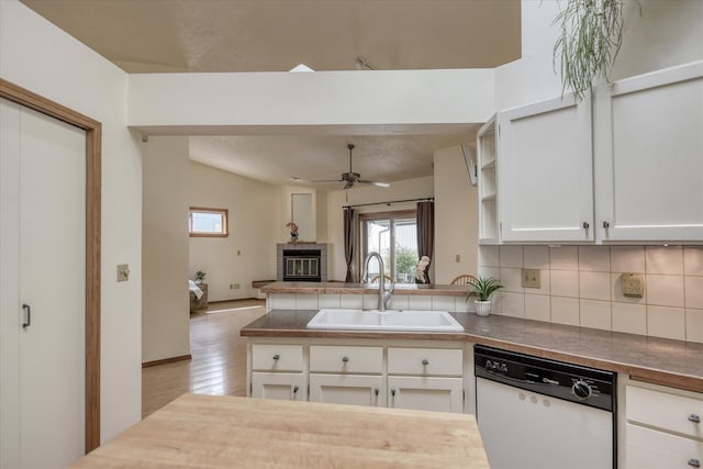 6923 N Hamilton St Unit 6923, Spokane, WA 99208 - kitchen featuring white dishwasher, a sink, a peninsula, backsplash, and wood finished floors