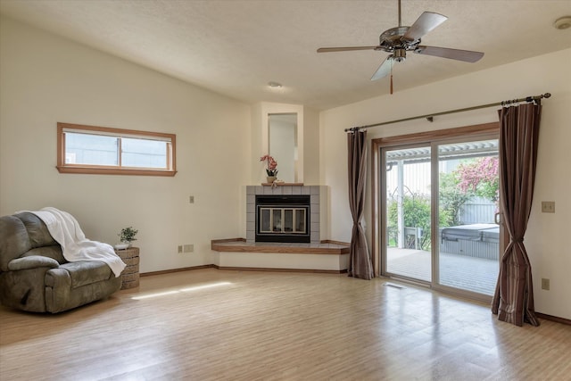 6923 N Hamilton St Unit 6923, Spokane, WA 99208 - sitting room with light wood-type flooring, a tile fireplace, baseboards, and ceiling fan