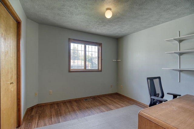 6923 N Hamilton St Unit 6923, Spokane, WA 99208 - unfurnished office with wood finished floors, baseboards, and a textured ceiling