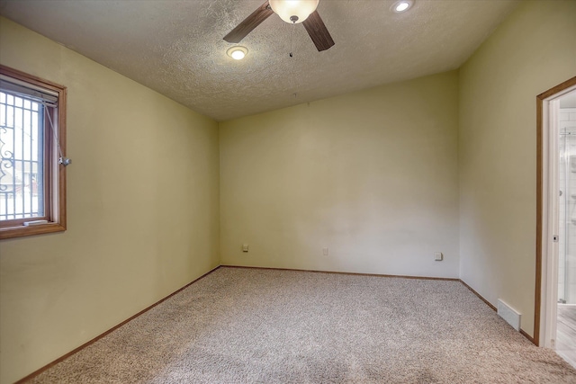 6923 N Hamilton St Unit 6923, Spokane, WA 99208 - spare room with light carpet, a ceiling fan, a textured ceiling, and baseboards