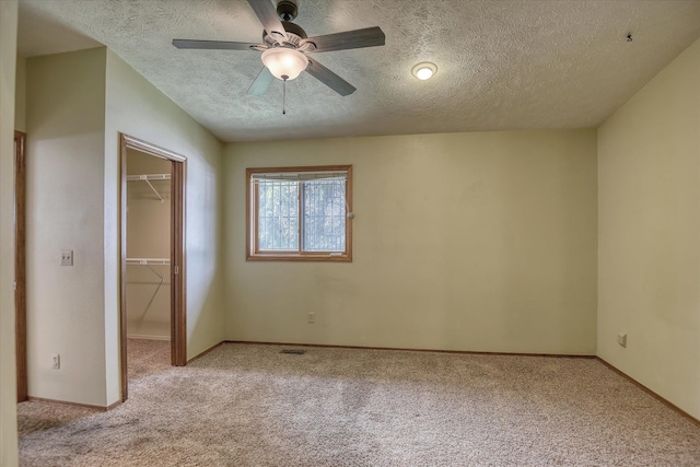 6923 N Hamilton St Unit 6923, Spokane, WA 99208 - unfurnished bedroom featuring a walk in closet, light carpet, a textured ceiling, and a closet