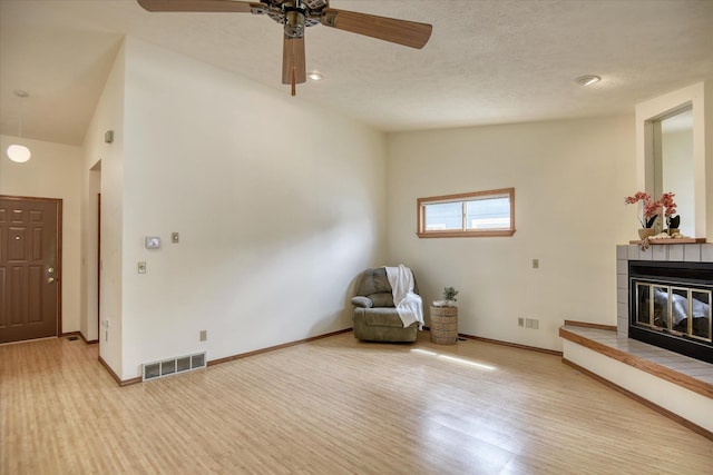 6923 N Hamilton St Unit 6923, Spokane, WA 99208 - sitting room with ceiling fan, a fireplace, baseboards, and light wood-type flooring