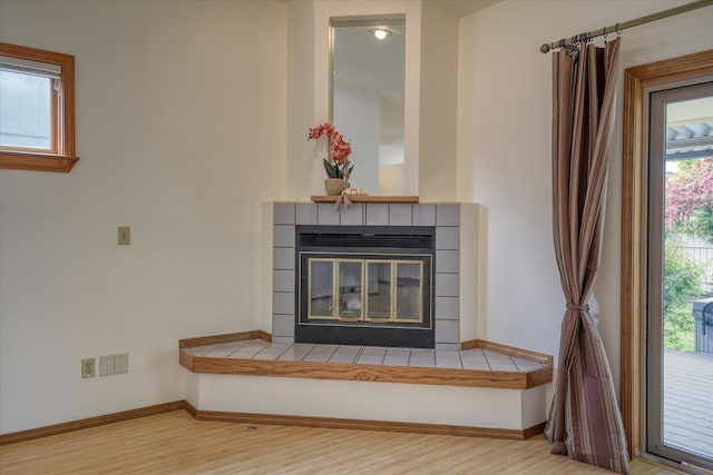 6923 N Hamilton St Unit 6923, Spokane, WA 99208 - detailed view of wood finished floors, baseboards, and a tiled fireplace