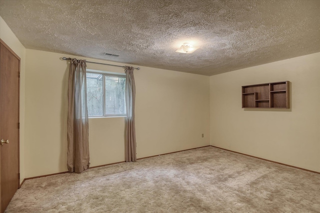 6923 N Hamilton St Unit 6923, Spokane, WA 99208 - empty room featuring a textured ceiling, light carpet, and baseboards