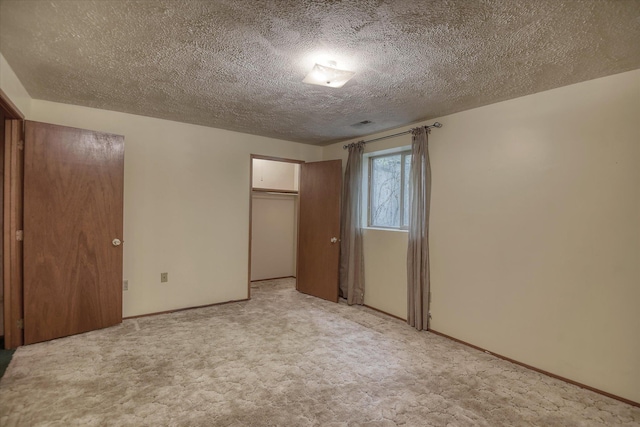 6923 N Hamilton St Unit 6923, Spokane, WA 99208 - unfurnished bedroom featuring a textured ceiling, a closet, carpet, and baseboards