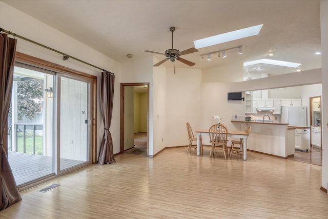 6923 N Hamilton St Unit 6923, Spokane, WA 99208 - dining area featuring light wood-style flooring, a skylight, rail lighting, baseboards, and ceiling fan