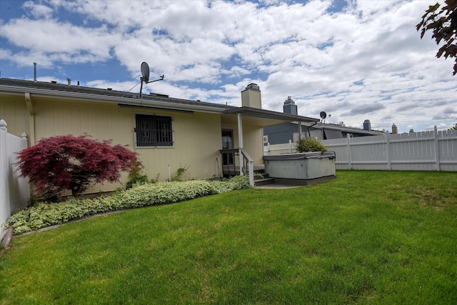6923 N Hamilton St Unit 6923, Spokane, WA 99208 - rear view of house featuring a hot tub and a chimney