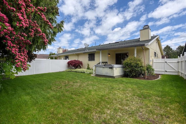 6923 N Hamilton St Unit 6923, Spokane, WA 99208 - rear view of house with a hot tub and a chimney