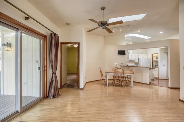 6923 N Hamilton St Unit 6923, Spokane, WA 99208 - dining room with light wood-style floors, a skylight, lofted ceiling, a ceiling fan, and baseboards