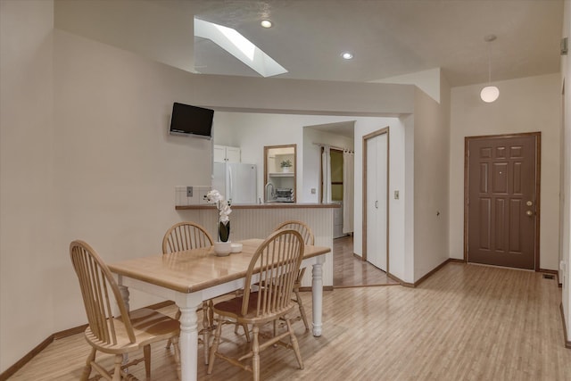 6923 N Hamilton St Unit 6923, Spokane, WA 99208 - dining area featuring a skylight, baseboards, and light wood finished floors