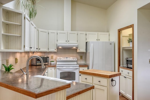 6923 N Hamilton St Unit 6923, Spokane, WA 99208 - kitchen featuring white appliances, under cabinet range hood, tasteful backsplash, butcher block countertops, and a peninsula