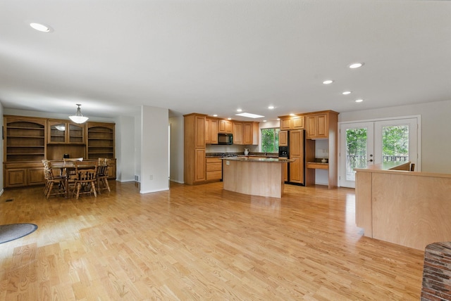 kitchen featuring paneled built in refrigerator, plenty of natural light, a center island, recessed lighting, and black microwave