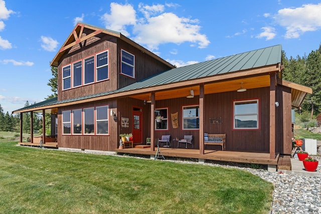 view of front of property with a standing seam roof, metal roof, and a front yard