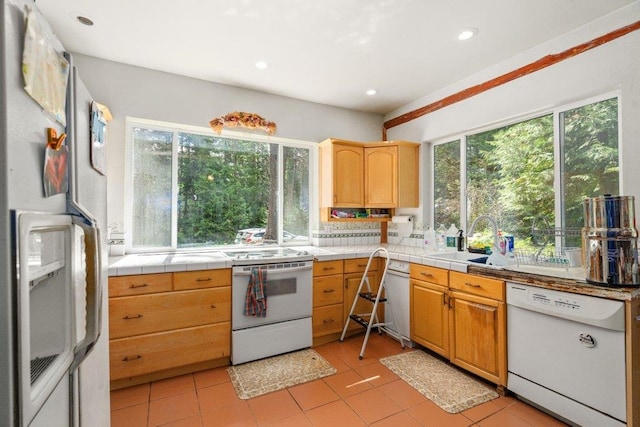 652 Penny Ln, Usk, WA 99180 - kitchen with white appliances, a sink, tile counters, light tile patterned floors, and recessed lighting