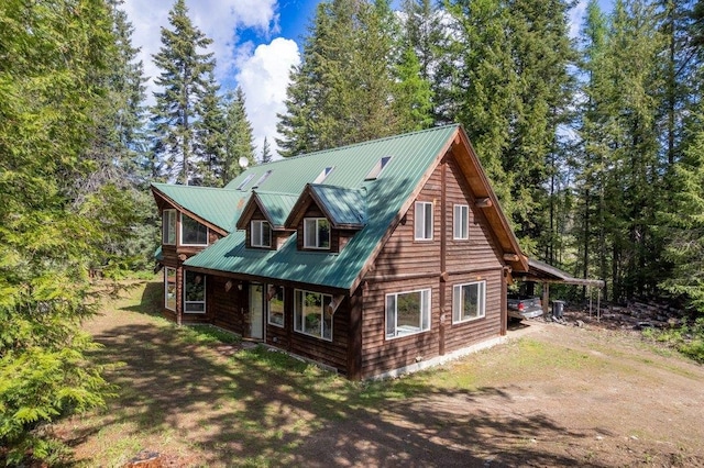 652 Penny Ln, Usk, WA 99180 - cabin with dirt driveway and metal roof