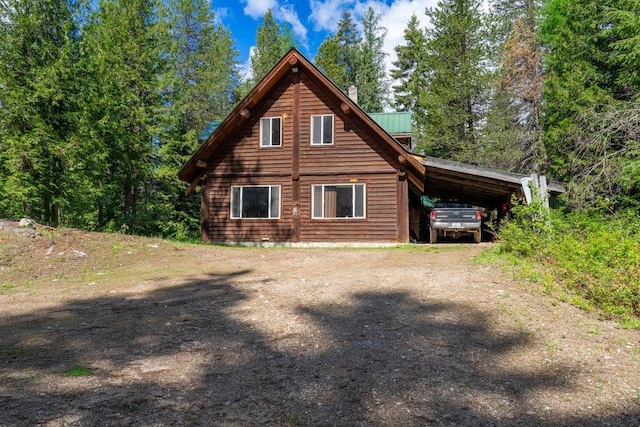 652 Penny Ln, Usk, WA 99180 - view of side of home with a carport, driveway, and metal roof