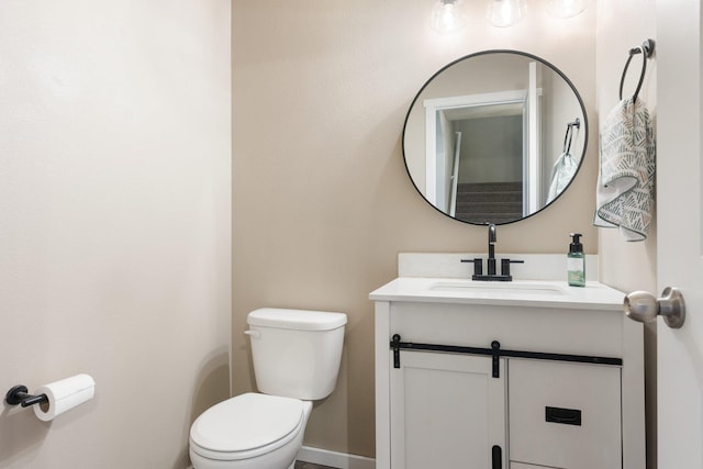 bathroom with toilet and vanity