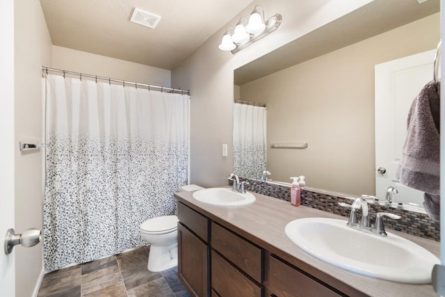 full bathroom with toilet, double vanity, tasteful backsplash, and curtained shower