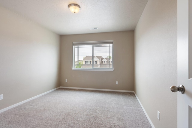 unfurnished room with carpet flooring and baseboards