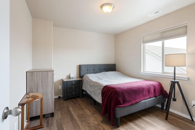 bedroom featuring dark wood-style floors and baseboards