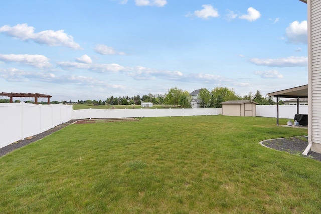 view of yard featuring a shed and an outdoor structure