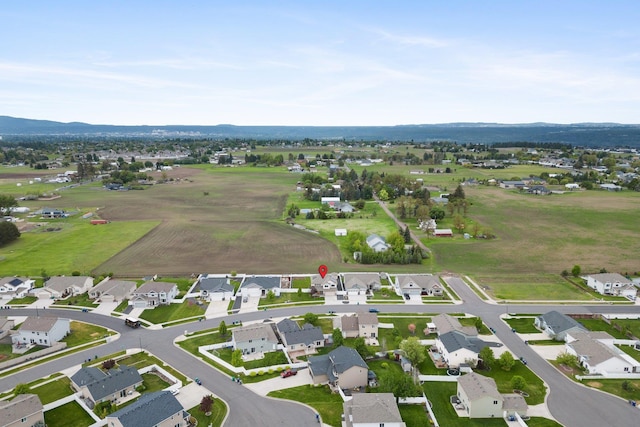 aerial overview of property's location with nearby suburban area and a mountain backdrop