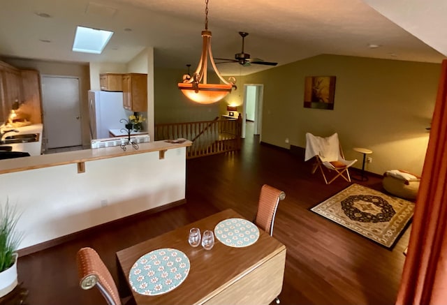 1610 S Newer Ln Unit 0, Spokane Valley, WA 99037 - dining space with a skylight, lofted ceiling, dark wood-type flooring, a ceiling fan, and baseboards