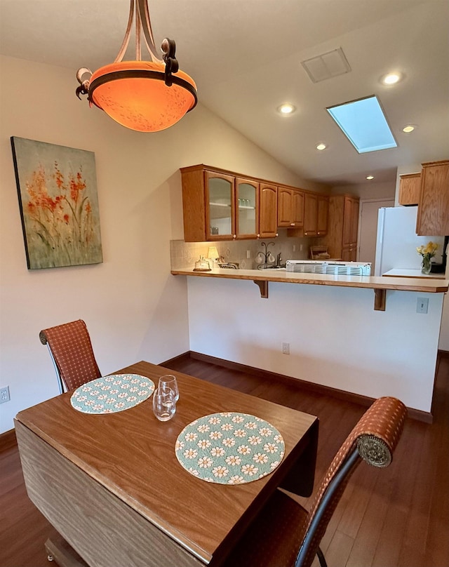 1610 S Newer Ln Unit 0, Spokane Valley, WA 99037 - dining space featuring dark wood-style flooring, baseboards, lofted ceiling, recessed lighting, and a skylight