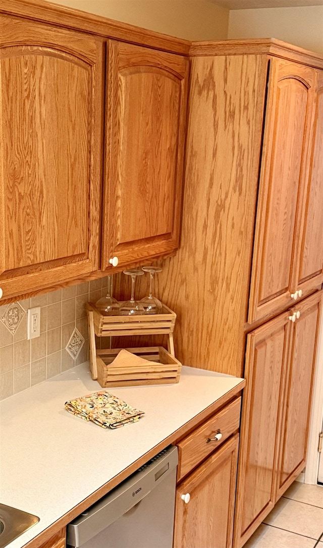1610 S Newer Ln Unit 0, Spokane Valley, WA 99037 - kitchen featuring dishwashing machine, light countertops, tasteful backsplash, and light tile patterned floors