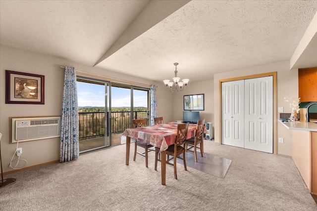 172 S Coeur Dalene St Unit G304, Spokane, WA 99204 - dining space with a chandelier, a wall mounted AC, light colored carpet, a textured ceiling, and baseboards