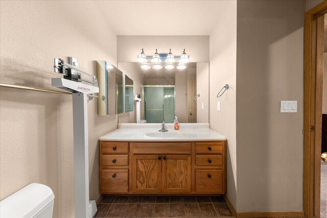 172 S Coeur Dalene St Unit G304, Spokane, WA 99204 - full bath featuring toilet, vanity, a shower with shower door, and baseboards