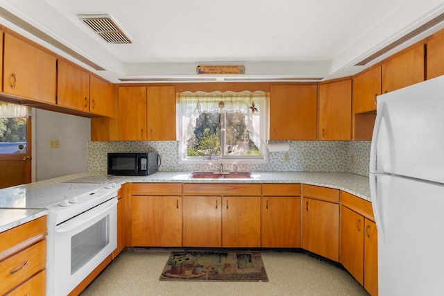 4345 Wilcox Rd, Northport, WA 99157 - kitchen with white appliances, light countertops, a sink, and plenty of natural light