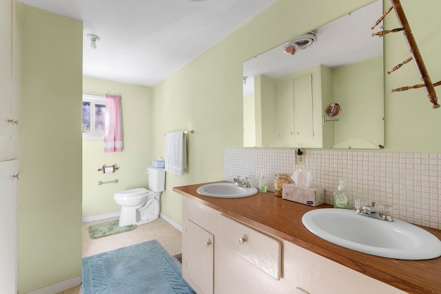 4345 Wilcox Rd, Northport, WA 99157 - bathroom featuring tasteful backsplash, toilet, double vanity, and baseboards