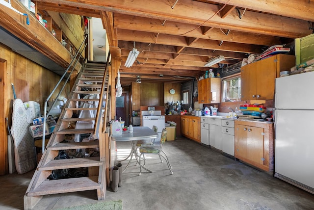 4345 Wilcox Rd, Northport, WA 99157 - basement featuring freestanding refrigerator, stairs, and wooden walls