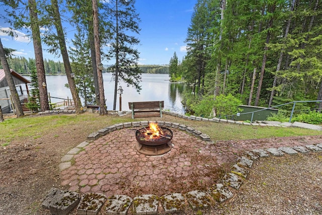 231 Mountain View Dr, Newport, WA 99156 - view of yard featuring an outdoor fire pit, a water view, and a wooded view
