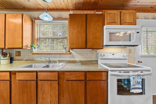 231 Mountain View Dr, Newport, WA 99156 - kitchen featuring white appliances, wooden ceiling, light countertops, tasteful backsplash, and brown cabinetry