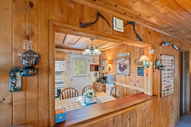 231 Mountain View Dr, Newport, WA 99156 - dining area with wood ceiling, wood walls, and a chandelier