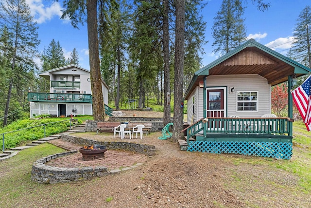 231 Mountain View Dr, Newport, WA 99156 - view of yard with a fire pit, a deck, and a porch