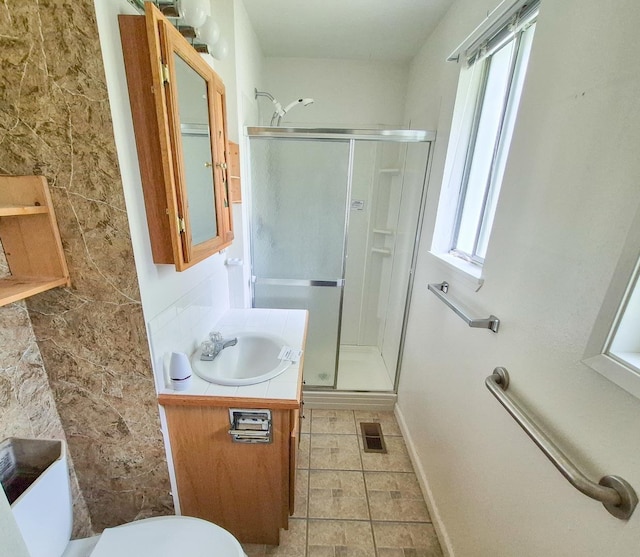 306 S Bernard St, Chewelah, WA 99109 - full bathroom with a stall shower, plenty of natural light, vanity, and toilet