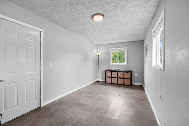 8214 N Jefferson Dr, Spokane, WA 99208 - unfurnished bedroom featuring a textured ceiling and baseboards