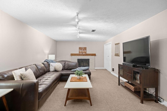 8214 N Jefferson Dr, Spokane, WA 99208 - living room with light colored carpet, a textured ceiling, track lighting, a brick fireplace, and baseboards