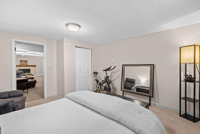 8214 N Jefferson Dr, Spokane, WA 99208 - carpeted bedroom featuring a textured ceiling, a fireplace, baseboards, and a closet
