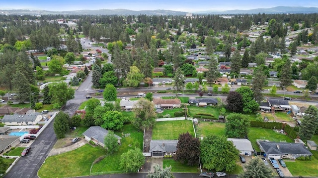 8214 N Jefferson Dr, Spokane, WA 99208 - aerial overview of property's location with a mountainous background and nearby suburban area