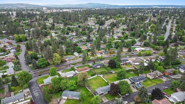 8214 N Jefferson Dr, Spokane, WA 99208 - aerial view of property's location with a mountain backdrop and nearby suburban area