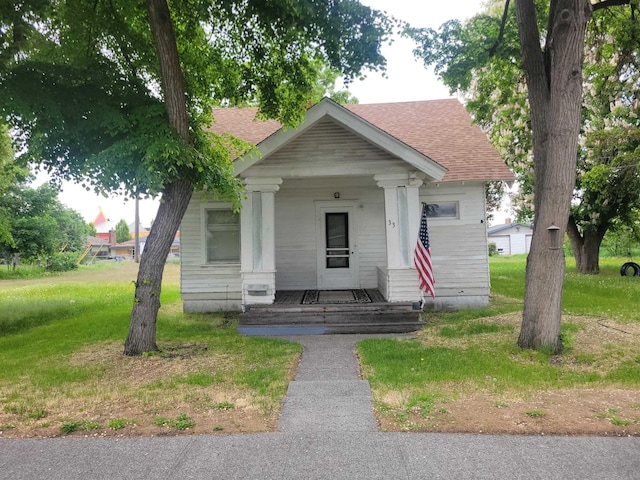 33 E Everett Ave, Spokane, WA 99207 - shotgun-style home with roof with shingles, a porch, and a front lawn