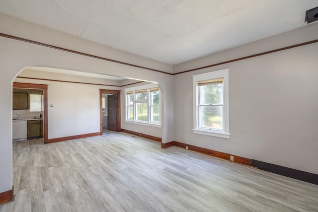 33 E Everett Ave, Spokane, WA 99207 - empty room with arched walkways and light wood finished floors