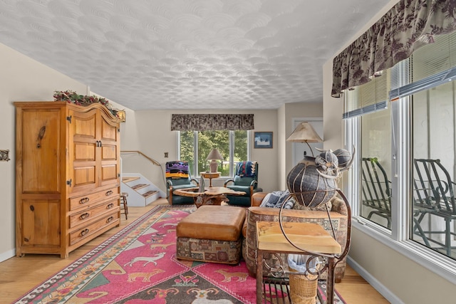 2443 Flowery Trail Rd, Usk, WA 99180 - living area with light wood-type flooring, stairs, and baseboards