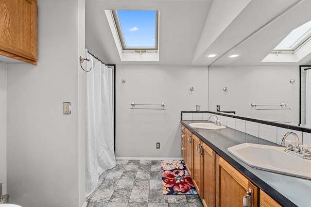 2443 Flowery Trail Rd, Usk, WA 99180 - full bathroom with a skylight, baseboards, recessed lighting, double vanity, and stone finish floors